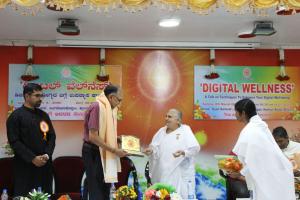 7. BK Sharada Behn presenting the Godly gift to  D.Sudhanwa, CEO, Excelsoft Technologies, Mysore