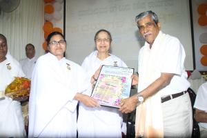 8. BK Kamalesh Behn Presenting the Godly gifts to Sri Mahendra Saliyan