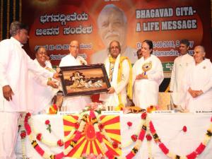 9. BK Lakshmiji presenting the Godly gift to Prof. K. Keshava Murthy